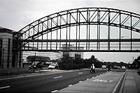 Pedestrians walking under pedestrian bridge at Prince George's Plaza.