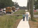 School children on a new sidewalk.