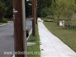 Utility poles in grass planting strip.
